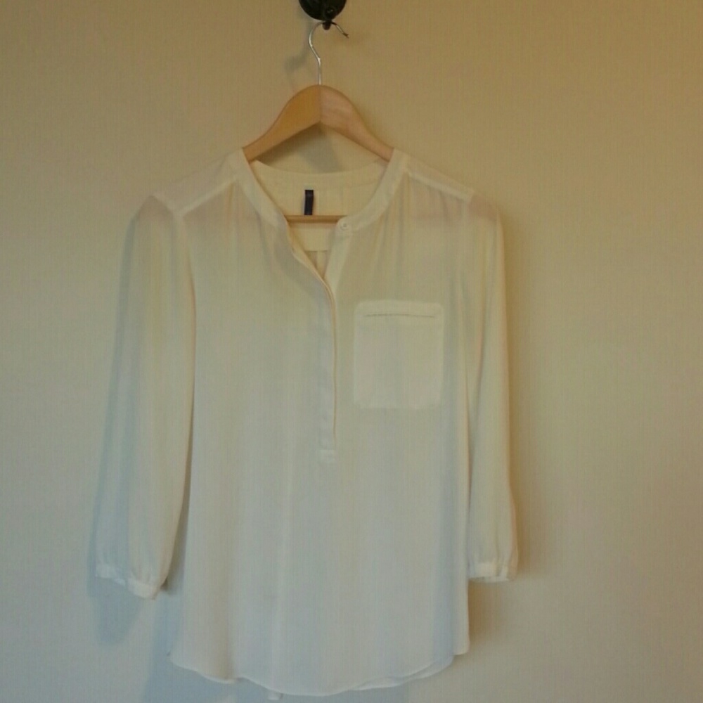 Semi-sheer cream blouse.